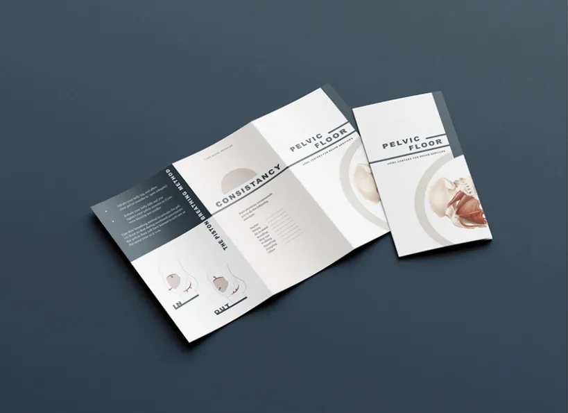 Patient leaflet on pelvic floor training, folded open on a dark surface